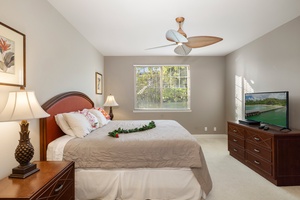 The spacious primary suite is filled with natural light and coastal charm, offering direct access to the ensuite bathroom.
