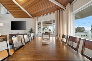 Gather around this spacious dining table where your group can enjoy meals together under stunning wood-beam ceilings with natural light streaming in.