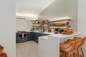 Modern kitchen design with open shelving, quartz counters, and premium appliances.