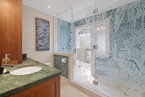 The downstairs shared guest bathroom has a single vanity and separate shower.