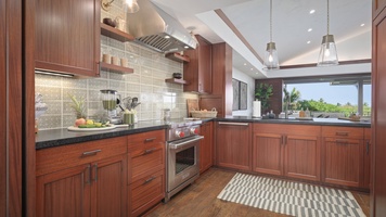 The spacious kitchen area features wide counter spaces for a breezy meal prepping.