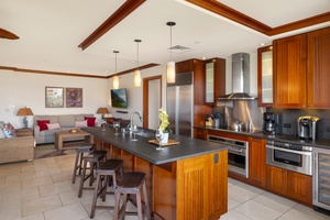 The kitchen has bar seating and a wine fridge.