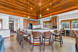 The chef’s kitchen includes modern appliances, bar seating, and plenty of prep space for casual or gourmet meals.