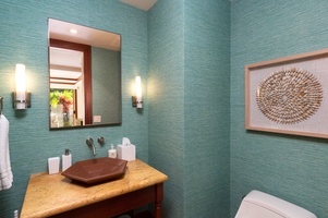 The powder room off of the great room is immersed in blue