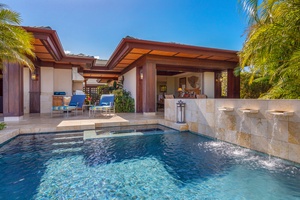 Private pool with peaceful water features and shaded seating.