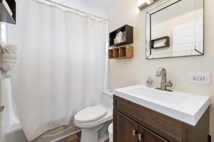 Primary bathroom with a tub/shower combo, ideal for unwinding after a day of exploring.