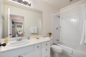 Bright and clean full bathroom with tub/shower combo—great for families or post-beach rinses.