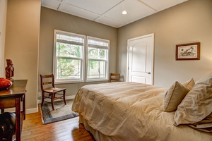 Bedroom 4 has a queen size bed and views out to the gardens