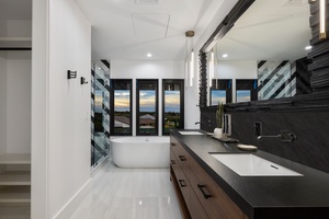 Refresh in the spa-inspired ensuite, designed for tranquil moments with panoramic sunset views.