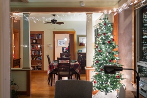 Dining room with a beautifully lit Christmas tree, ready for holiday celebrations.