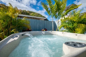 Rest and recharge in the luxurious hot tub, surrounded by lush tropical landscaping for the ultimate island relaxation.