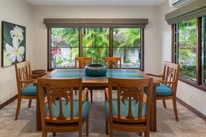 Tennis house dining area with seating for 6, ideal for enjoying meals with garden views.
