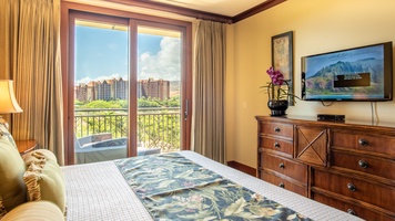 The primary guest bedroom with a TV and dresser.