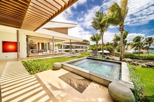 Soak in the jacuzzi on the deck,  offering a serene view of the lush garden and ocean.