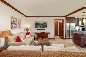 Sink into plush seating where warm wood accents meet tropical elegance, creating your perfect retreat for movie nights and morning coffee.