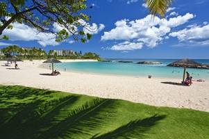 The view of the Ko Olina lagoon with beach cabanas on the side.