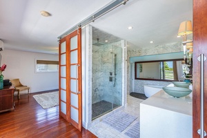 The spa-inspired primary ensuite features a custom-tiled walk-in shower for your luxurious retreat.