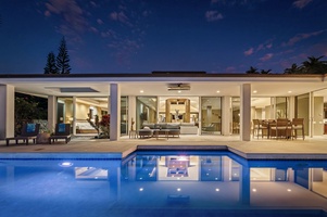 Take an evening dip in the glowing pool just steps from your open-air living space.