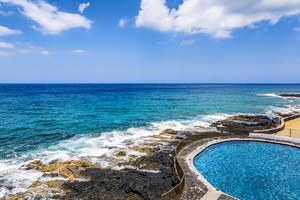 Take in dramatic oceanfront views from the edge of the saltwater pool, where lava rock meets sea.