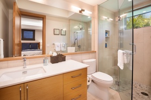 Enjoy the comfort of a luxury bath with granite counters, glass-enclosed shower, and resort vibes.