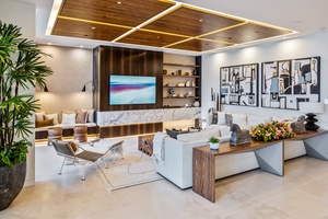 Cozy up for a movie night in the media lounge, featuring a sleek TV wall and modern design.