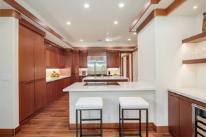 Spacious kitchen with breakfast bar designed for casual dining and meal prep.