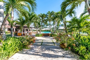 Lush tropical garden pathway leading to the pool area.