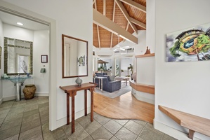 The stunning open-plan retreat with soaring wooden ceilings, warm hardwood floors, and an elegant spiral staircase.