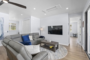 The upstair living area features plush sectional seating and a smart TV.