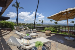 Expansive lanai with plush seating, ocean views, and swaying palm trees for ultimate relaxation.