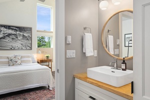 The ensuite connects to the bedroom and is bright, simple, and stylish.