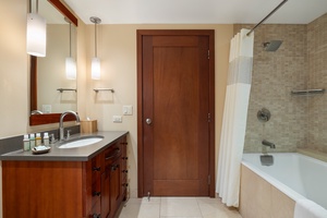 The shared guest full bathroom has a shower and tub combo.