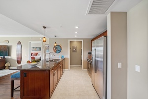 A bright galley-style kitchen at Honua Kai Konea 204 connects beautifully to the rest of the open-concept home.