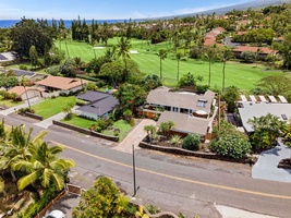 From overhead, the home nestles into a green, leafy stretch of Kailua Kona.