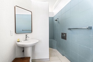 Modern minimalist guest bath with oversized walk-in shower, perfect for both quick rinses and long, restorative moments.