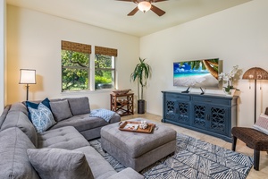 Relax in the stylish living room with flat-screen TV, plush sectional seating, and tranquil fairway-facing windows.