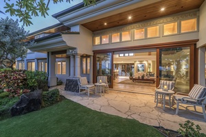 Oceanside main house living room access, sliding glass doors open to palm‑framed views.