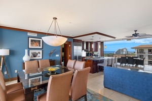 Relax in your stylish open-plan living space with stunning ocean views through floor-to-ceiling windows and elegant modern furnishings.