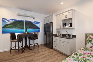Twin bedroom with kitchenette, providing a private, functional retreat with dining and lounging areas.