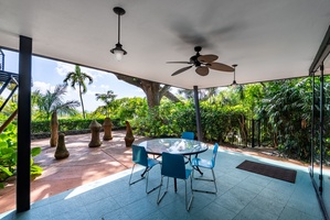 Relax on the covered lanai, feeling the island breeze as you soak in the peaceful rainforest setting.