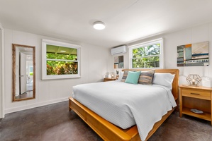 Unwind in your bright, serene bedroom with crisp linens, modern furniture, and tropical garden views that invite natural light and peaceful island vibes.