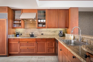 Gourmet modern kitchen fully equipped with top tier appliances.