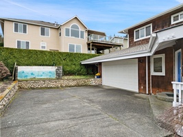 Convenient driveway with garage access provides easy arrival to this coastal neighborhood home.
