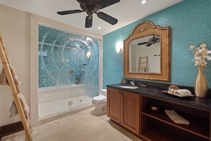 The downstairs shared guest bathroom has a single vanity and separate shower.