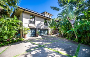 Exterior view of Pili Pono surrounded by lush landscaping.
