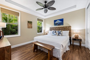 Rest easy in the first guest suite at Kona Blue Vacations Holua Kai, featuring a king bed and ceiling fan.
