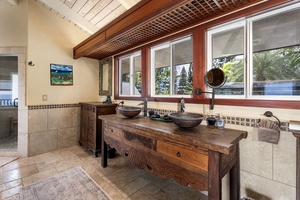 Lanai-adjacent full bathroom with exterior entrance—ideal for rinsing off after a beach day or pool session.