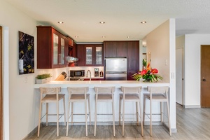 Prepare meals in style with smooth Corian countertops, modern appliances, and plenty of prep space for island feasts.