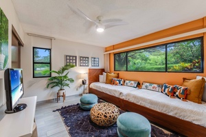 Comfortably accommodate family or friends in the stylish guest room with two twin beds and views of the tropical greenery.