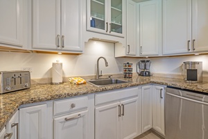 Modern kitchen at Kaanapali Shores 213 with granite counters and ample storage space.